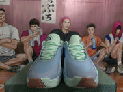 Front view of pale blue Nike sneakers with mint green laces, collars, and outsole accents.