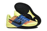 Yellow, blue, and orange Nike low-top basketball shoes with black outsoles.