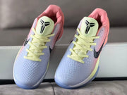 Front view of the pair showing the Kobe logo on the tongues and pale yellow laces.