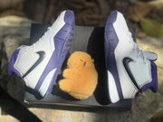 Overhead view of the pair showing the black Swoosh branding, white laces, and purple outsole sections.