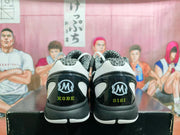 Rear view of the sneakers showing Kobe and Gigi text with matching circular heel logos.