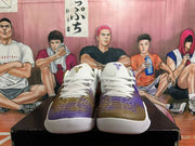 Front view showing white laces and purple-to-gold gradient patterned toes