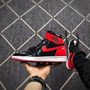Black and red high-top sneaker shown in side profile with a white midsole and red outsole.