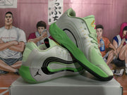 Angled view of the green and white basketball sneakers displayed together on a box.