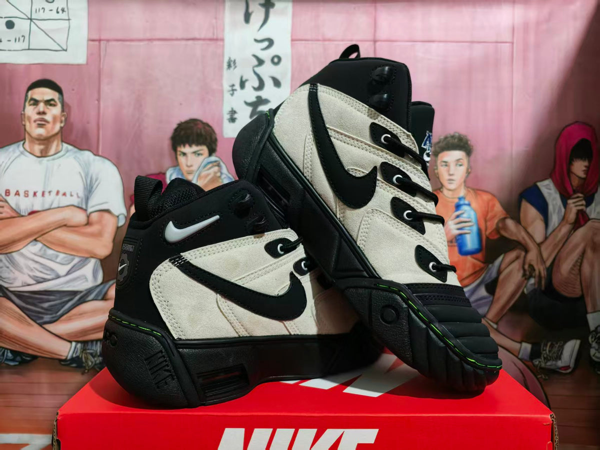 Pair of black and cream Nike high-top sneakers shown from an angled front view on a Nike shoebox.