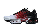 Side view of a Nike Air Max Plus sneaker showing its white-to-red gradient upper and black heel.