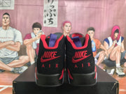 Rear view of the black and red high-top sneakers showing Nike branding, Air lettering, and purple collar details.
