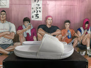 Side profile of a white Nike slide showing the textured strap, molded footbed, and outsole.