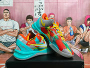 Pair of multicolor Nike basketball sneakers with turquoise, red, yellow and gray panels, photographed on a black box.