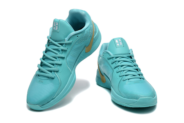 Pair of aqua Nike Sabrina basketball shoes with gold-colored Swoosh accents, shown from above and the front.