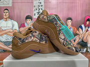 Angled view of the brown Nike sneakers showing the camouflage-patterned upper, purple Swoosh and low-top profile.