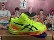 Side view showing the neon yellow ASICS sneaker, black branding, red heel detail, and translucent outsole section.