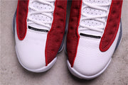 Close-up of the white toe panels, laces, and red patterned overlays.