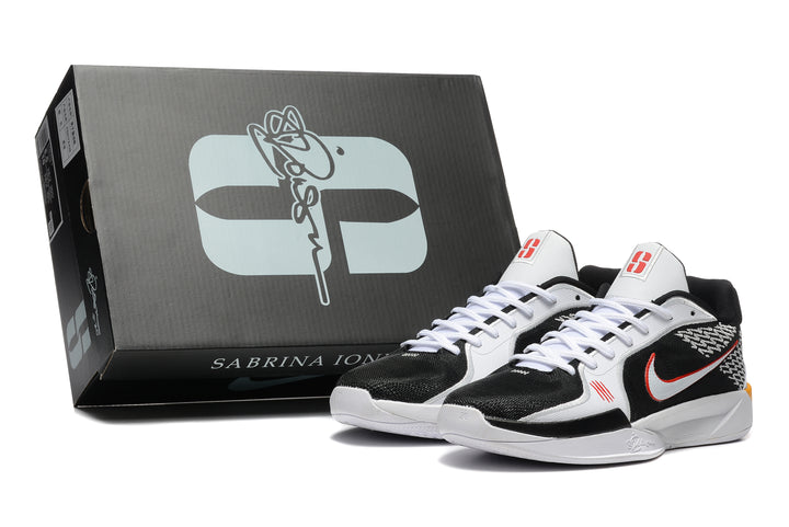 Black, white, and red Nike Sabrina basketball shoes beside a branded box
