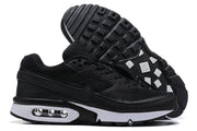 Pair of black Nike Air Max sneakers showing mesh panels, white midsoles, visible air units, and patterned outsole.