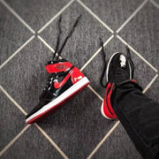 High-top sneaker resting on a patterned floor, viewed from an angled side perspective.