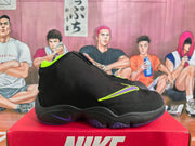 Side view of a black Nike high-top sneaker with a large purple and neon yellow Swoosh and a sculpted purple-and-black sole.