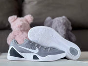 Grey and white low-top shoe beside an outsole view showing its patterned tread.