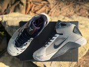 Top view of the pair showing the padded collars, dark laces, tongue branding, and patterned upper details.