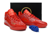 Red Nike LeBron 23 basketball shoes displayed with a black shoebox and blue laces.
