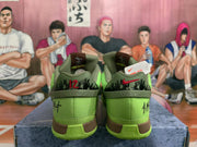 Rear view of bright green Nike basketball sneakers showing dark heel graphics, olive collars, and brown midsole accents.