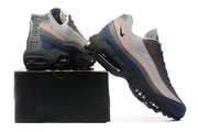 Pair displayed on a black box, showing the layered uppers and visible sole cushioning