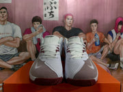 Front view showing the white laces, perforated forefoot panels, burgundy accents, and textured burgundy outsoles.