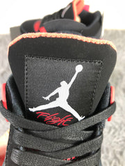 Close-up of the black tongue with a white Jordan logo and red script detail.