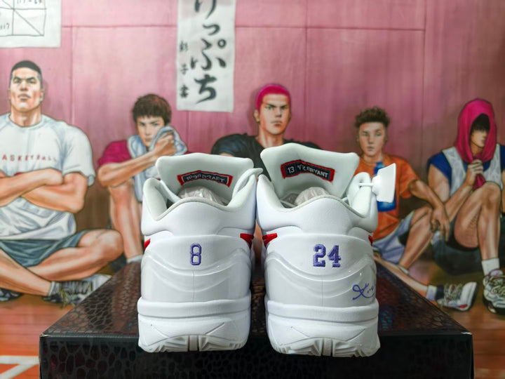 Rear view of white basketball shoes showing heel number graphics and Kobe Bryant tongue labels.