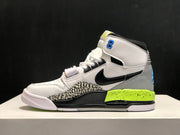 Side profile of one sneaker showing the grey heel, black Swoosh, elephant-print panel and neon yellow midsole.