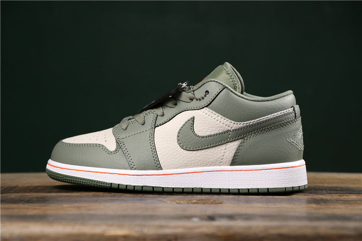 Gray-green low-top Jordan sneaker shown in side profile, with a light side panel, matching swoosh, heel branding, and a white midsole with an orange accent line.