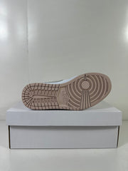 Underside view showing the light bone rubber outsole with circular traction details.