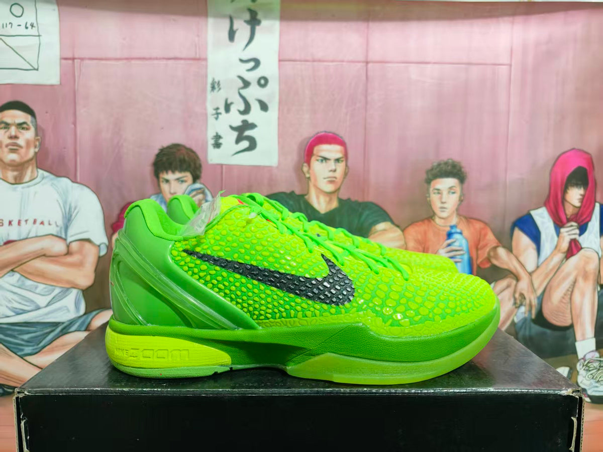 Side view of bright green Nike KD-style basketball sneakers with a textured upper, black side branding, and green midsole.