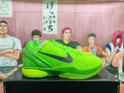 Side view of bright green Nike KD-style basketball sneakers with a textured upper, black side branding, and green midsole.