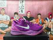 Side view of purple Nike sneakers with white Swoosh logos and textured purple soles.
