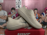 Angled side view showing the perforated upper, layered sole, and dark side Swoosh-style branding.