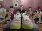 Front view of pink and white Nike Ja 3 basketball shoes with white laces and vivid lime-colored soles.