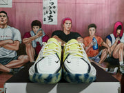 Front view of Nike basketball sneakers showing white uppers, lime collars, black trim, white laces, and blue-tinted outsoles.