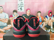 Rear view showing Jordan branding and patterned panels on the black and red shoes.