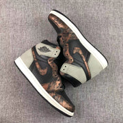 Angled overhead view of the pair highlighting the bronze-toned overlays and white midsoles.