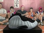 Side view of a white and black Nike Foamposite-style high-top sneaker.