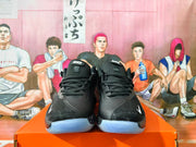 Front view of black Nike basketball shoes with black laces and translucent outsoles.