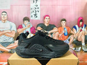 Side view of a black Nike basketball shoe with lace-up closure and sculpted outsole