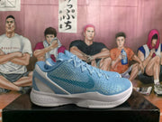 Side view of a blue Nike Kobe basketball shoe with raised upper texture and white midsole