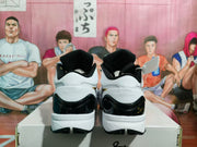 Rear view showing the padded collars, glossy black heel panels, white midsoles, and black outsoles.