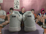 Rear view of the white speckled sneakers showing '12:AM' heel text and geometric heel emblems.