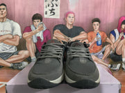 Front view of the gray Nike sneakers showing tonal laces, textured uppers, and black toe outsoles.