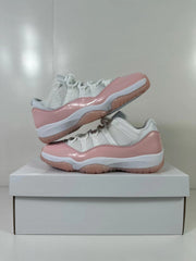 Two pink and white sneakers arranged together, with one shoe elevated above the other.