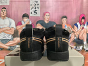 Rear view of black Nike Sabrina basketball shoes with gold accents and heel pull tabs.