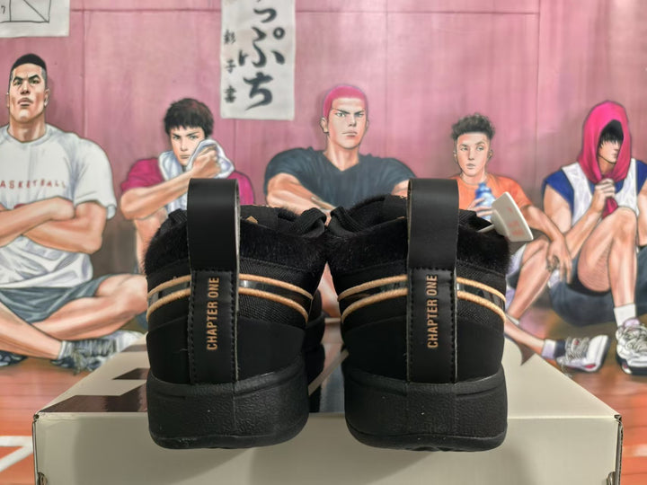 Rear view of black Nike Sabrina basketball shoes with gold accents and heel pull tabs.